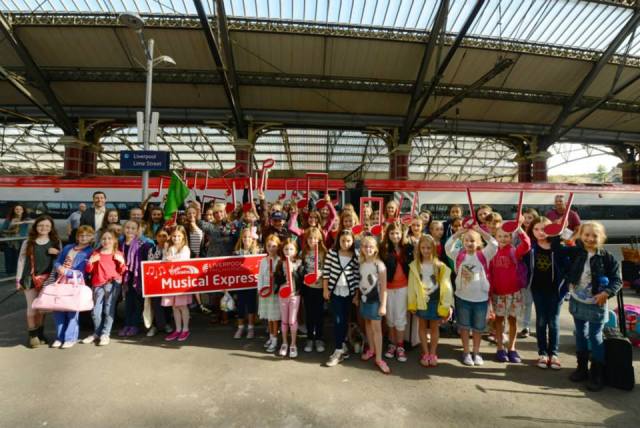The West Everton Children's Orchestra, The In Harmony team and the combined youth choirs of the Royal Liverpool Philharmonic await to board the Liverpool Philharmonic Muical Express to London to play with the RLPO at the BBC Proms 2013